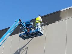 commercial painting in moline illinois by Shambaugh painting with the use of a JLG for safety reason